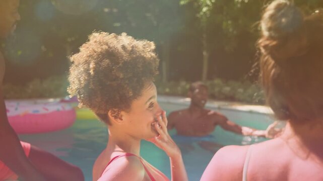 Woman leaning, starting chat, touching friend, causing motion labels on pool float and beer for ads