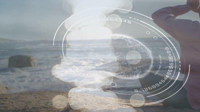 Woman forming meditative mudra on shore on HUD pulse, bokeh passing over her for wellness
