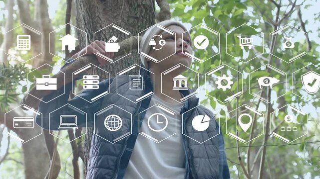 Man leaning on tree holding stick, hex icons appearing and man lifting hand, analyzing tech data