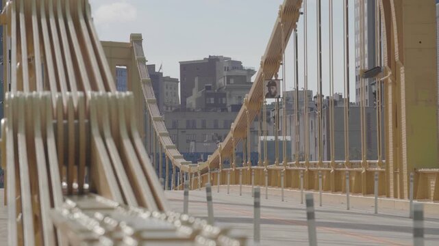 Close-up detail of Roberto Clemente Bridge structure with downtown skyline in background