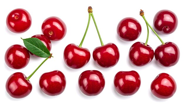Overhead shot of ripe, red cherries with green stems and leaves against white