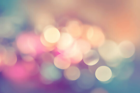 Soft, glowing, out-of-focus circles in pastel shades of pink, purple, and teal