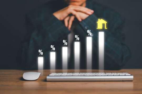 Businessman analyzing real estate market trends with a rising bar graph and house icon, symbolizing growth and investment.