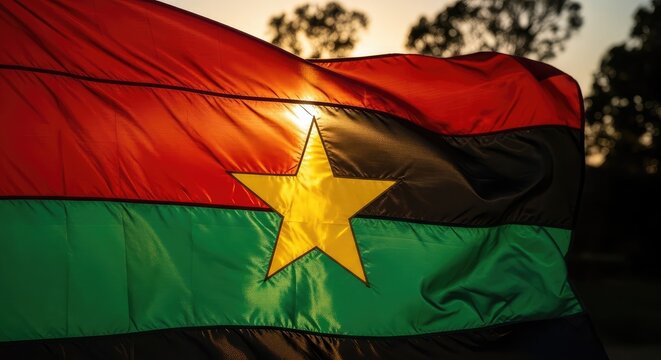 The national flag of burkina faso waving in the sunlight