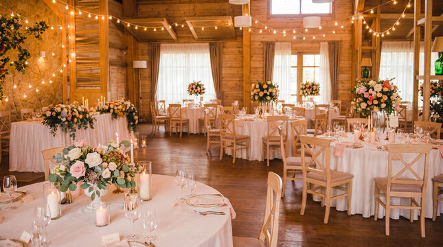 Beautifully decorated wedding reception hall with multiple tables, floral arrangements, and string lights.