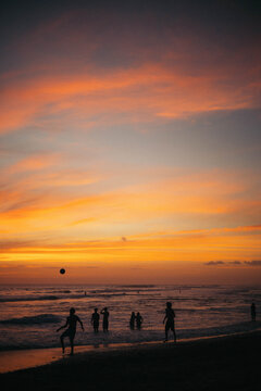 people playing footaball at the beach