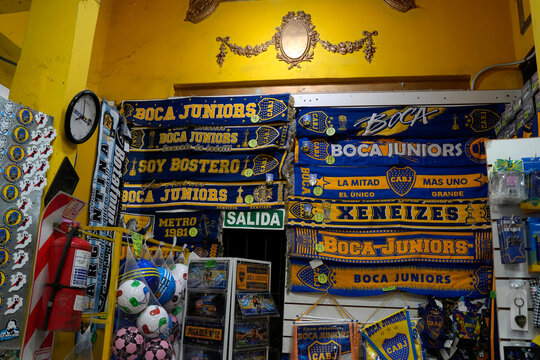 BUENOS AIRES, ARGENTINA - JANUARY 15 2026 - La Boca is a popular destination with colourful houses and pedestrian street, lot of maradona and messi murals and boca junior soccer team merchandise