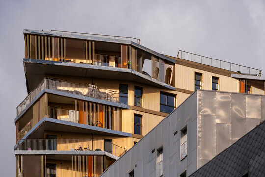 Rooftop terraces shape Paris France modern residential apartment facade with windows and skyline presenting urban architecture and clean exterior elevation
