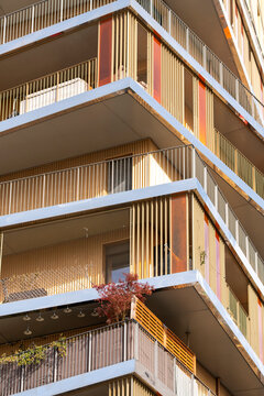 Sunlight defines Paris France urban residential apartment facade with balconies and lines showing modern architecture across the exterior and housing detail