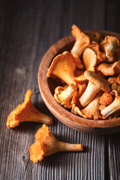 Chanterelle mushrooms on wooden table creating rustic still life. Wild mushrooms, organic food, autumn harvest