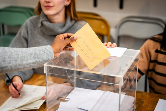 Voters casting ballots in transparent ballot box during elections