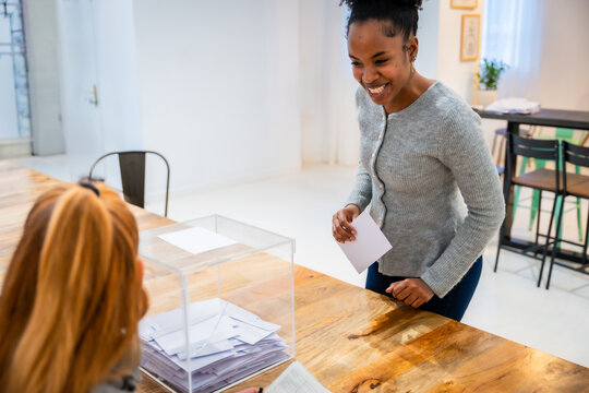 African american woman casting ballot in election