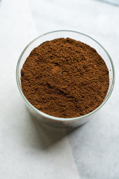 Closeup of a rich freshly ground coffee powder in glass jar