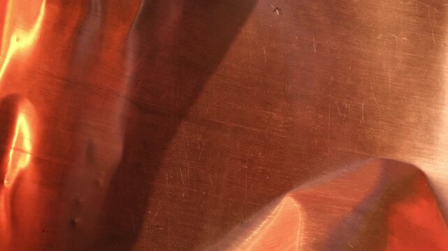 Bent copper sheet shines in the sun. Abstract backgrounds for design. Minimal.