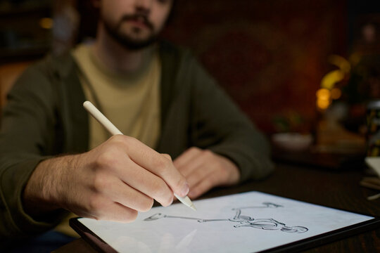 Freelancer drawing a skeleton on a graphics tablet indoors