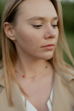 Portrait of woman outdoors in spring park with neutral expression