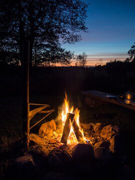 Cozy campfire burning outdoors at sunset in Estonia