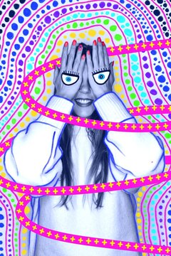 Hands covering face with drawn eyes and colorful psychedelic pattern