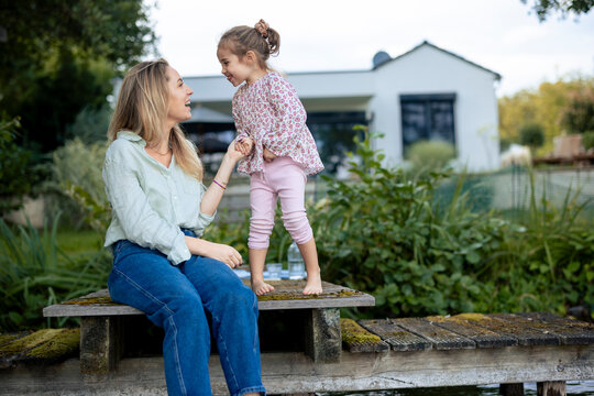 Happy daughter enjoying with mother on pier