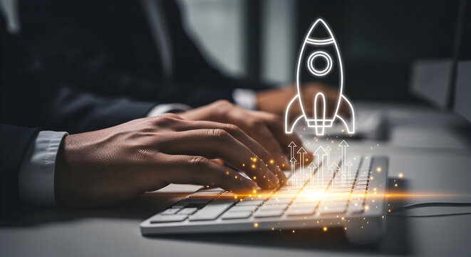 Business person typing on a keyboard with a digital rocket launch icon and upward arrows representing growth, startup success, and innovation
