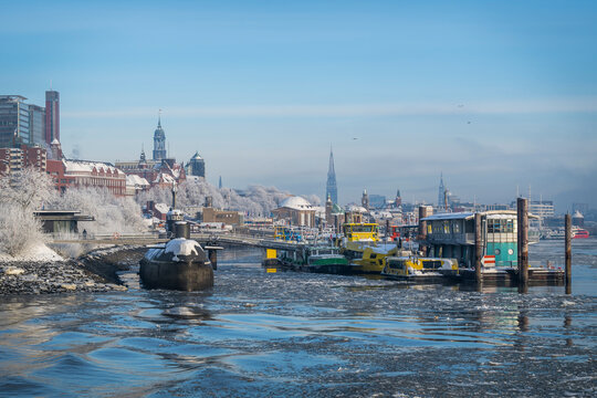 Winter cityscape of Hamburg with submarine and icy river