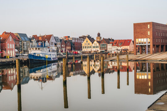 Harbor view with reflection and boat in Husum Germany
