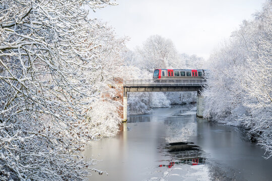 Subway train crossing bridge over Goldbekkanal in winter in Hamburg