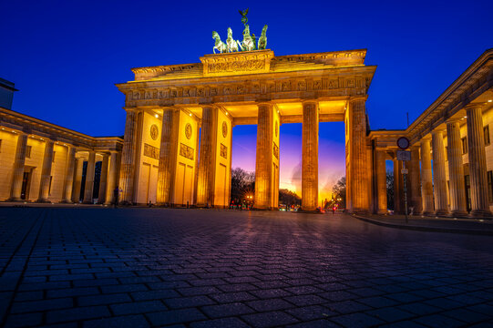Illuminated Brandenburg Gate in Berlin at dusk with no people
