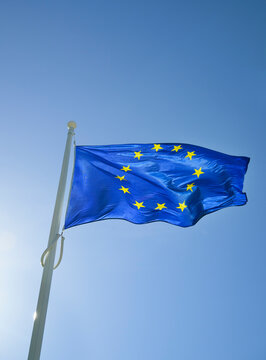 European Union flag blowing in the wind against a clear blue sky