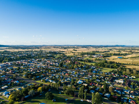 Neat town planning shown in aerial view over rural town in bright summer sunshine