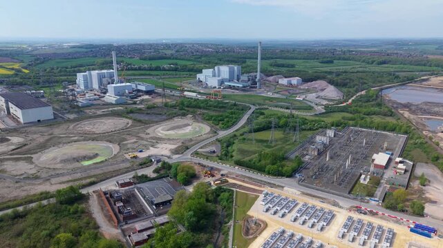 Aerial view of massive modern waste to energy generation power plants with smoking chimneys in Ferrybridge West Yorkshire UK