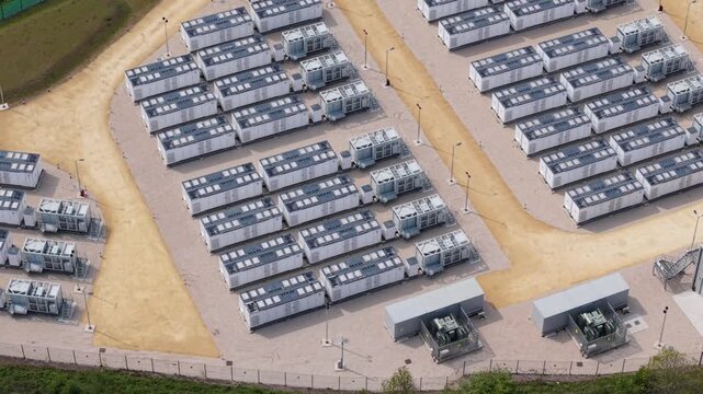 Close up aerial view of modular Sungrow battery energy storage systems BESS units in rows near Ferrybridge UK