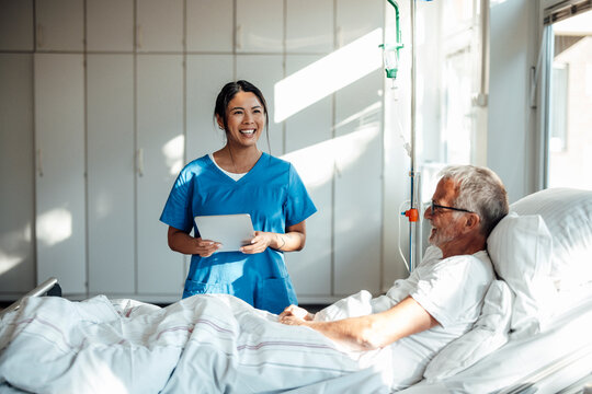 Nurse providing care and support to a patient in a hospital room