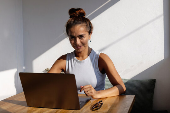 confident smiling enthusiastic woman with laptop computer, portrait looking at camera
