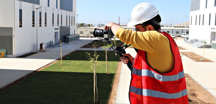 Professional videographer filming construction architecture