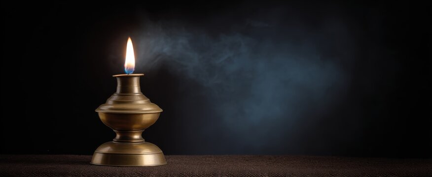 An isolated authentic antique oil lamp flickers like a whisper from the past