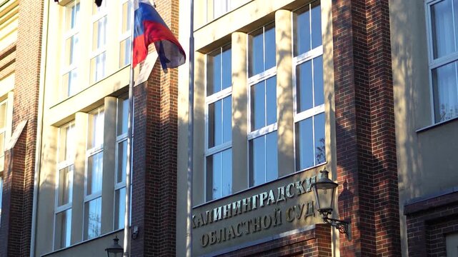 Kaliningrad Regional Court. Courthouse and entrance with flag, justice building in Kaliningrad.
