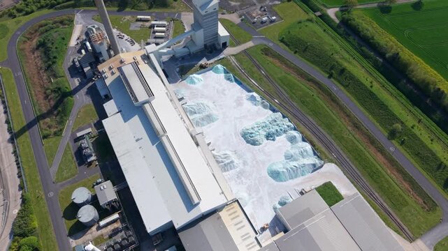 Aerial view of raw cullet piles of recycled glass material at an industrial site in Goole UK