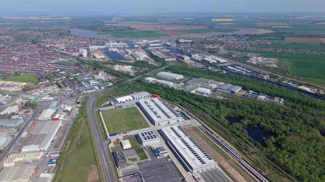 Commercial shipping port and inland docks with industrial warehouses, aerial view, Goole, UK.
