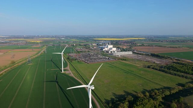 Aerial perspective of an industrial electrical substation and renewable energy wind turbines at Keadby power station UK