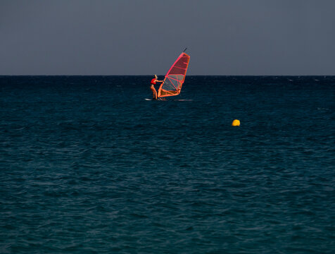 Windsurfing at Kalafati Beach in the Aegean Sea of Mykonos Island in Greece.