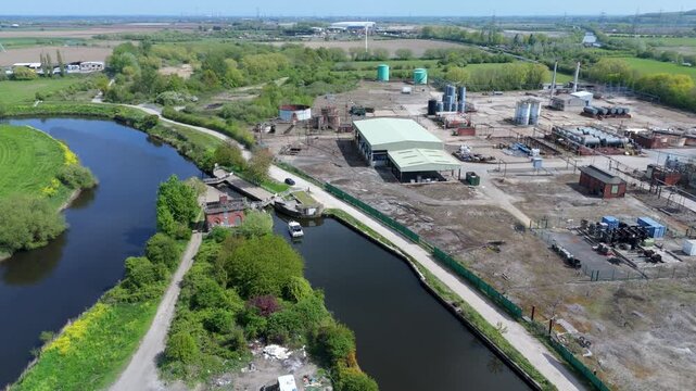 Aerial drone view of a small private yacht waiting for lock gates to open to pass downstream on the River Aire in Knottingley UK