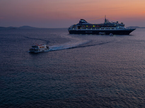 Mykonos, Greece, August 20, 2024: Cruise ship at the port on the island of Mykonos in Greece at sunset