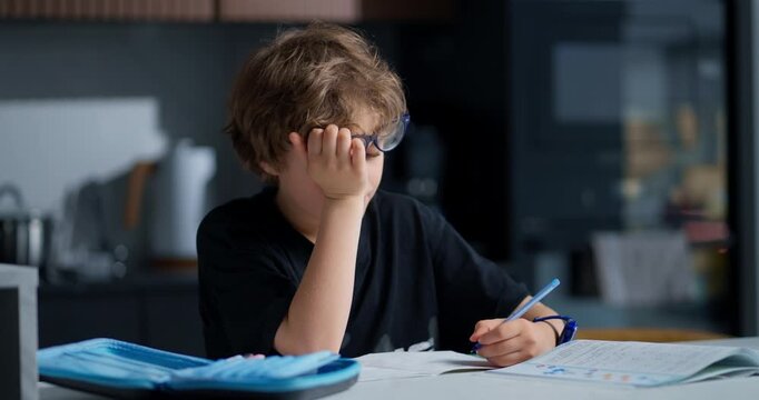Boy Homework Frustration. Young Boy Contemplates Hard Homework Amid Sighs And Silent Frustration