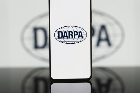 DARPA logo displayed on a smartphone screen, Defense Advanced Research Projects Agency branding on mobile device for military technology, innovation, and scientific research communication