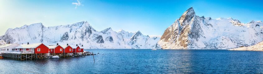 Traditional Norwegian red wooden houses (rorbuer) on the shore of  Reinefjorden near Hamnoy village © TBOM