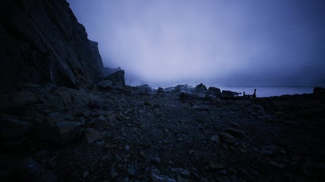 rocky trail along coastline under bluehour sky, scattered boulders and distant sea stacks, cinematic solitude perfect for travel and adventure storytelling.