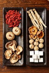 Fototapeta premium Dried Chili and Root Ingredients Arranged on Dark Slate