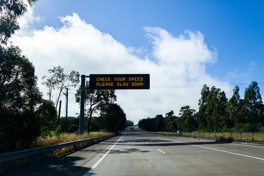 check your speed please slow down sign over Australian highway