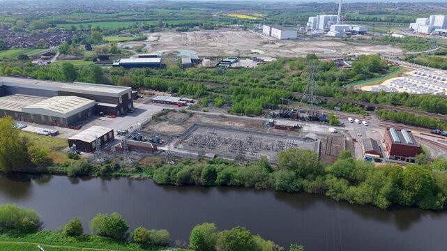 Aerial view of a small electrical substation with high-voltage lines and switchgear infrastructure in Ferrybridge, UK.
